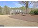 A long driveway leading to a single Gathering home, enhanced by landscaping and mature trees at 115 Foxford Run, Tyrone, GA 30290