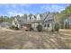 Attractive single Gathering house with stone accents, dormer windows, and beautiful landscaping at 115 Foxford Run, Tyrone, GA 30290