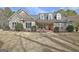 Charming single-Gathering home with stone accents, three dormer windows, and a bright red front door at 115 Foxford Run, Tyrone, GA 30290
