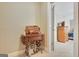 Hallway featuring a vintage sewing machine table leading to an open doorway with a view of the bedroom at 115 Foxford Run, Tyrone, GA 30290