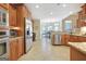 Bright open kitchen with stainless steel appliances, wooden cabinets, and ample counter space at 115 Foxford Run, Tyrone, GA 30290