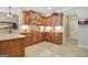 Well-lit kitchen showcasing custom wooden cabinets, updated appliances, and ample counter space at 115 Foxford Run, Tyrone, GA 30290