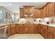 Gourmet kitchen featuring wood cabinetry, granite counters, and a tile backsplash, perfect for cooking at 115 Foxford Run, Tyrone, GA 30290