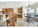 Open kitchen featuring a breakfast bar with seating, and a dining table near the window for sunlit meals at 115 Foxford Run, Tyrone, GA 30290
