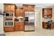 Kitchen includes modern stainless steel appliances, custom cabinetry, and a built-in home office at 115 Foxford Run, Tyrone, GA 30290