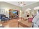 Open living room with a large television, hardwood flooring, and neutral furnishings at 115 Foxford Run, Tyrone, GA 30290