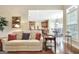Bright living room with hardwood floors, a comfortable couch, and lots of natural light at 115 Foxford Run, Tyrone, GA 30290