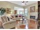 Cozy living room featuring a fireplace, hardwood flooring, and an open layout at 115 Foxford Run, Tyrone, GA 30290