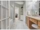 Bathroom featuring double sink vanity, walk-in shower, and tile floor at 115 Foxford Run, Tyrone, GA 30290