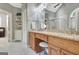 Bathroom vanity with double sinks, granite counters, and tiled floor at 115 Foxford Run, Tyrone, GA 30290