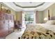 Bedroom with a patio view, dark wood dresser, and elegant decor at 115 Foxford Run, Tyrone, GA 30290
