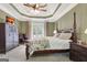 Main bedroom with tray ceilings, carpet floor, and french doors to backyard patio at 115 Foxford Run, Tyrone, GA 30290