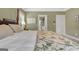 Side angle of bedroom showing a comfy bed and entrance to a bathroom at 115 Foxford Run, Tyrone, GA 30290