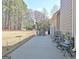 Patio with outdoor seating, including a heater, and a view of the expansive backyard surrounded by mature trees at 115 Foxford Run, Tyrone, GA 30290