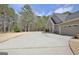 A long, paved driveway provides ample parking space next to an attached two-car garage at 115 Foxford Run, Tyrone, GA 30290
