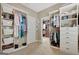 Spacious walk-in closet with custom shelves, hanging rods, and ample storage space for clothes and accessories at 115 Foxford Run, Tyrone, GA 30290