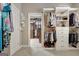 This walk-in closet is equipped with shelving, hanging rods, drawers and a view into another section of the closet at 115 Foxford Run, Tyrone, GA 30290
