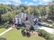 Stunning aerial view of a grand estate, showcasing its manicured grounds and lakeside setting at 125 Turnberry Cir, Fayetteville, GA 30215