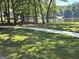Well manicured lawn with sidewalk with lake in the distance, perfect for nature lovers at 125 Turnberry Cir, Fayetteville, GA 30215