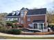 Brick home features a swimming pool enclosed with black metal fencing, with mature trees and a green lawn at 125 Turnberry Cir, Fayetteville, GA 30215