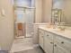 Bright bathroom features a glass shower enclosure with gold trim and a white vanity with gold hardware at 125 Turnberry Cir, Fayetteville, GA 30215