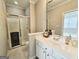 Bathroom view features a glass shower enclosure with gold trim and a white vanity with gold hardware at 125 Turnberry Cir, Fayetteville, GA 30215