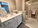 Bathroom boasts a white vanity with gold fixtures, a framed mirror, and shower with glass door at 125 Turnberry Cir, Fayetteville, GA 30215