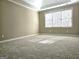 A light filled bedroom with plush carpeting and large windows at 125 Turnberry Cir, Fayetteville, GA 30215