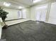 Versatile bonus room with a large mirror and access to the outdoors at 125 Turnberry Cir, Fayetteville, GA 30215