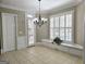A well-lit dining area with a chandelier and window seating, perfect for Gathering meals at 125 Turnberry Cir, Fayetteville, GA 30215