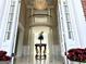 Grand foyer with soaring ceilings, elegant chandelier, white columns, and a view of the upper level balcony at 125 Turnberry Cir, Fayetteville, GA 30215
