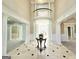 Expansive foyer with high ceilings, marble floors with contrasting black accents and an upper level balcony at 125 Turnberry Cir, Fayetteville, GA 30215