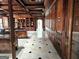 Hallway featuring marble floors and wood paneled walls, leading into a well appointed office at 125 Turnberry Cir, Fayetteville, GA 30215