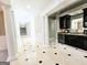 Elegant hallway featuring marble floors with black accents and decorative columns, leading to a refined bar area at 125 Turnberry Cir, Fayetteville, GA 30215