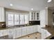 Well-lit kitchen featuring granite countertops, custom cabinetry, and a modern cooktop at 125 Turnberry Cir, Fayetteville, GA 30215