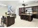 Open kitchen with stainless appliances, granite counters, dark cabinets, and a breakfast bar at 125 Turnberry Cir, Fayetteville, GA 30215