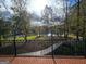 Scenic lake view with mature trees from an elevated deck with iron railing and brick flooring at 125 Turnberry Cir, Fayetteville, GA 30215