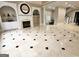 A spacious living room with a fireplace, built-in shelving, and elegant tile flooring at 125 Turnberry Cir, Fayetteville, GA 30215