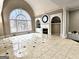 Spacious living space with grand fireplace, built-in shelving and a large arched window with natural light at 125 Turnberry Cir, Fayetteville, GA 30215