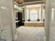 Luxurious main bathroom with a soaking tub, chandelier, and dual vanities surrounded by elegant finishes at 125 Turnberry Cir, Fayetteville, GA 30215