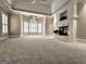 Bright main bedroom features a trey ceiling, fireplace, and large bay window offering ample natural light at 125 Turnberry Cir, Fayetteville, GA 30215
