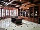 Spacious wood paneled office featuring custom built-ins, detailed trim and marble flooring at 125 Turnberry Cir, Fayetteville, GA 30215