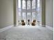 Bright sitting room with large arched windows, neutral carpet, offering a serene view at 125 Turnberry Cir, Fayetteville, GA 30215