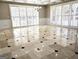 Sunlit room with large windows, elegant chandelier, and beautiful tile flooring at 125 Turnberry Cir, Fayetteville, GA 30215