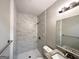 Bathroom with a tiled shower, granite vanity top, and updated fixtures at 4734 Campbellton Sw Rd, Atlanta, GA 30331