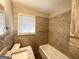 Bathroom with modern tile surround, granite vanity top, and updated fixtures at 4734 Campbellton Sw Rd, Atlanta, GA 30331