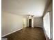 Bright living room with vinyl floors, ceiling fan, and neutral paint at 4734 Campbellton Sw Rd, Atlanta, GA 30331