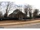 A charming community clubhouse with a brick and beige facade and a manicured lawn at 6008 Creekerton Blvd, Mcdonough, GA 30252