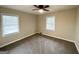 This bedroom has neutral paint, carpet and ceiling fan with two windows for plenty of natural light at 2030 Mark Trl, Decatur, GA 30032