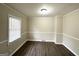 Inviting living room showcasing stylish dark floors, crown molding, and a bright window at 2030 Mark Trl, Decatur, GA 30032